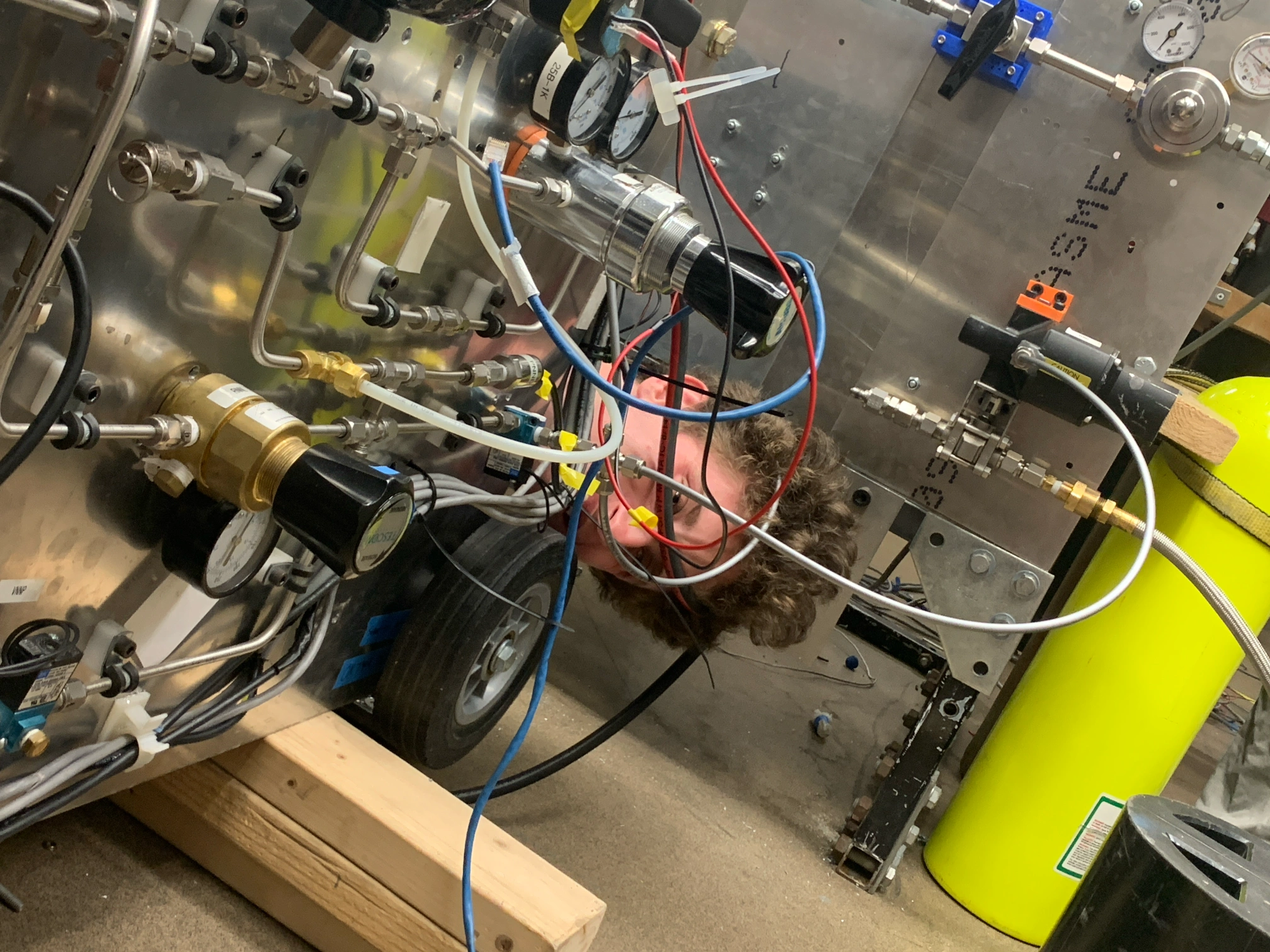Me working on the Horizontal Test Stand, peaking out from behind the pneumatics panel